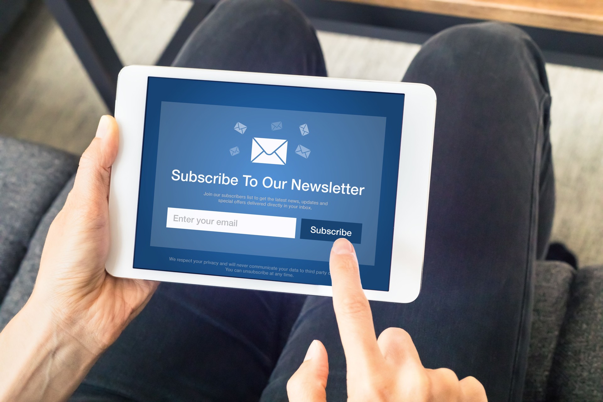 Subscribe to newsletter form on tablet computer screen to join list of susbscribers and receive exclusive offers and update. Digital communication marketing and email advertising. Membership sign-up